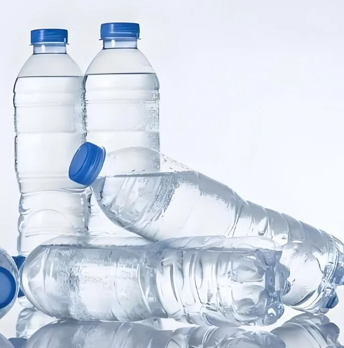 Bottled water: two standing, two on their sides. Blue caps.