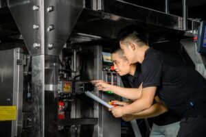 Technicians performing filling machine service and packaging equipment support.