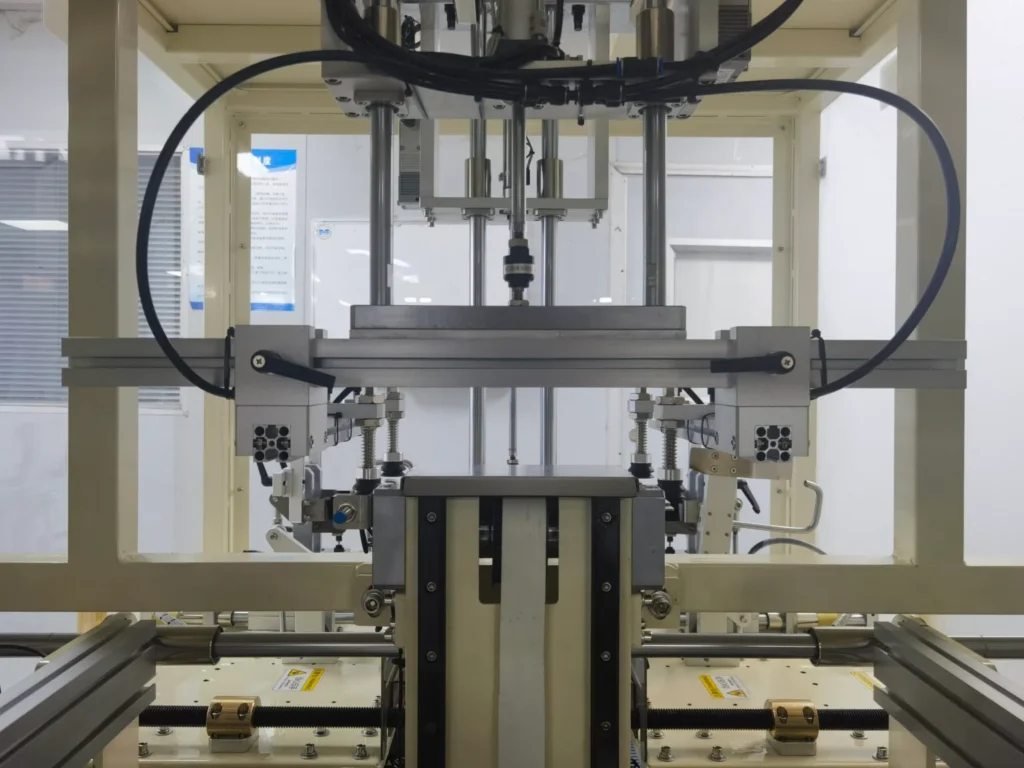 Close-up of a robotic arm working with packaging materials
