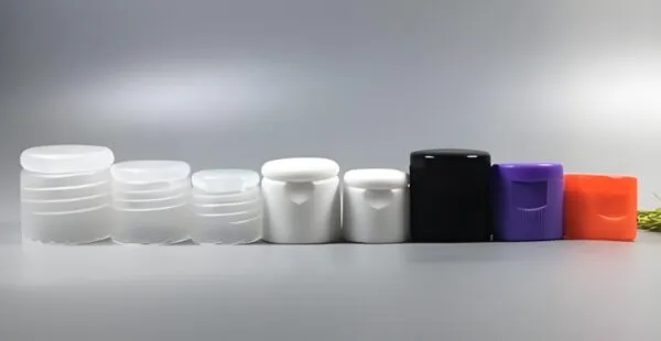 White plastic bottle caps arranged on a surface