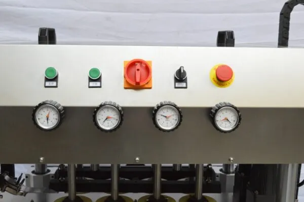 Control panel with pressure gauges and emergency stop buttons