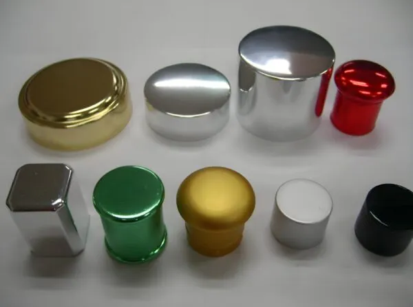 Assorted cosmetic bottle caps in different colors and finishes