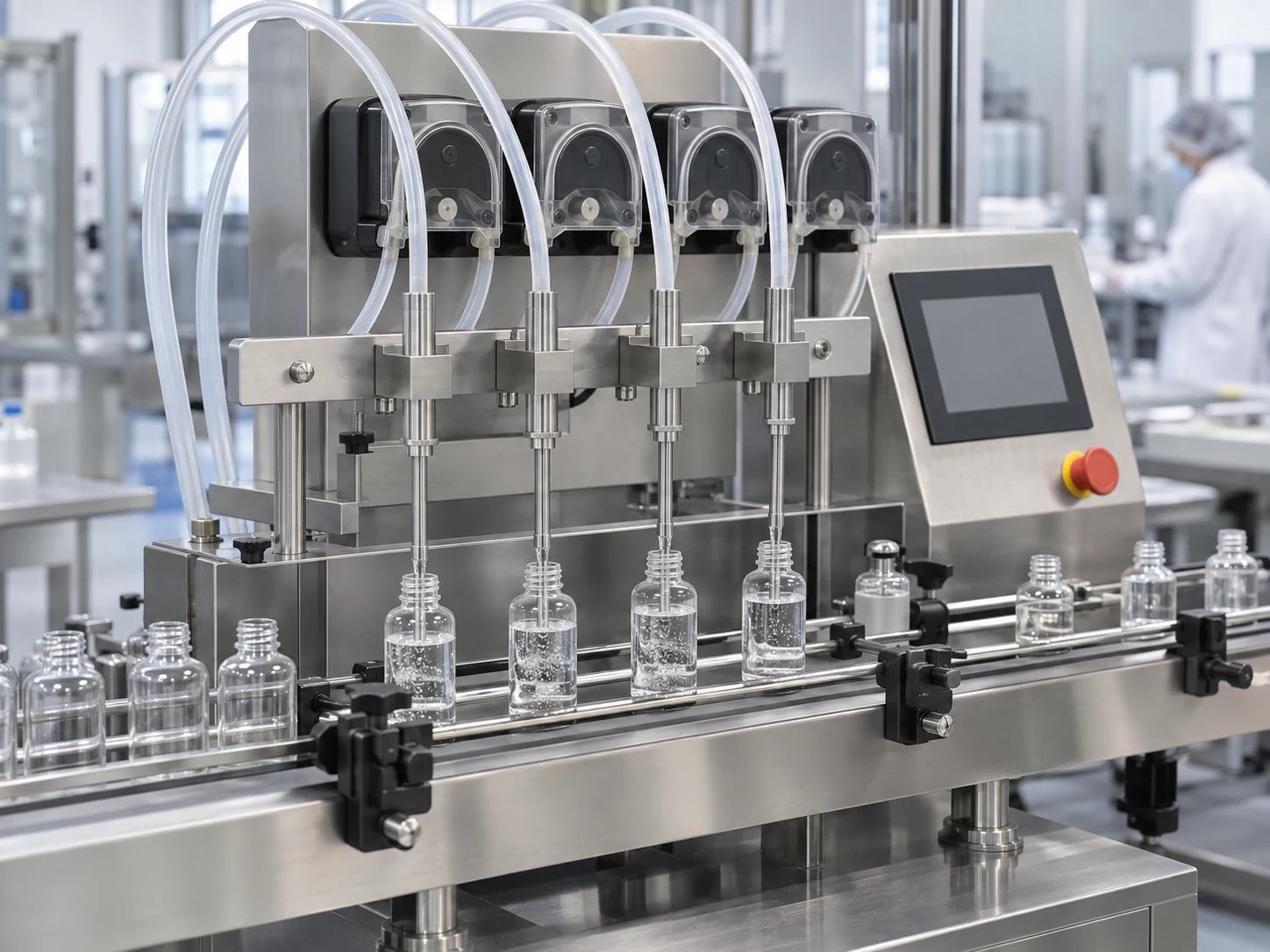Four-head peristaltic filling machine filling small bottles on an automated conveyor