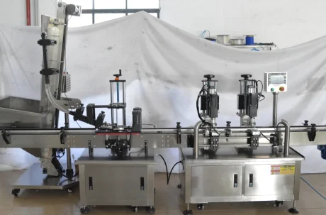 Close-up of the filling and capping machinery in action