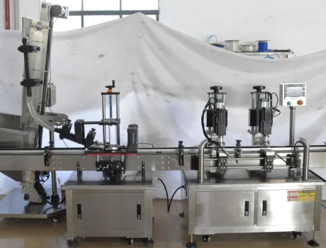 Close-up of the filling and capping machinery in action