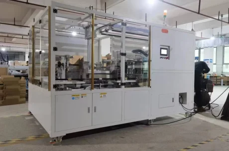 Paper Box Packaging Machine: automated system with safety enclosure and control panel.