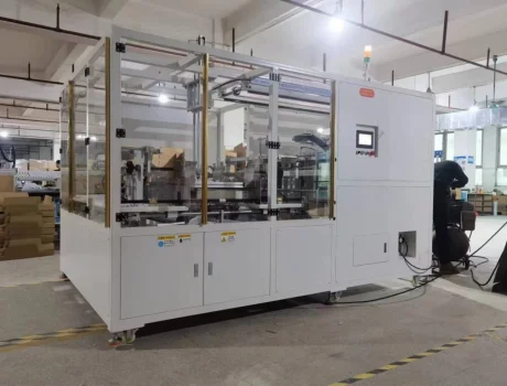 Paper Box Packaging Machine: automated system with safety enclosure and control panel.