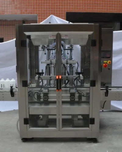 Automated bottle filling machine with stainless steel construction and a conveyor belt for modern packaging.