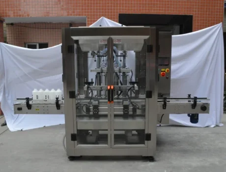 Automated bottle filling machine with stainless steel construction and a conveyor belt for modern packaging.