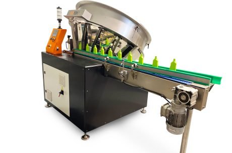 Automatic bottle unscrambler machine feeding plastic bottles into a packaging line