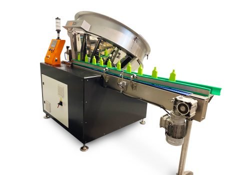 Automatic bottle unscrambler machine feeding plastic bottles into a packaging line