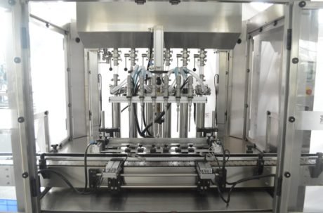 Stainless steel bottle filling heads inside automatic filling machine