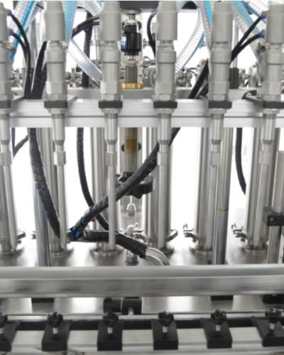 Multi-nozzle liquid filling machine with stainless steel heads