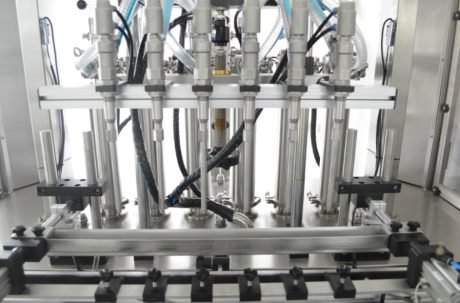 Multi-nozzle liquid filling machine with stainless steel heads