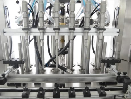 Multi-nozzle liquid filling machine with stainless steel heads
