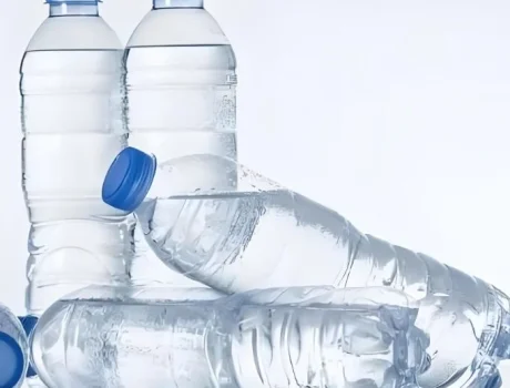 Bottled water: two standing, two on their sides. Blue caps.
