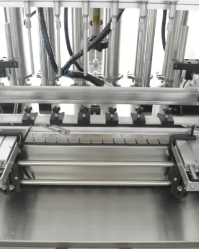 Close-up of a multi-nozzle filling machine for liquid packaging