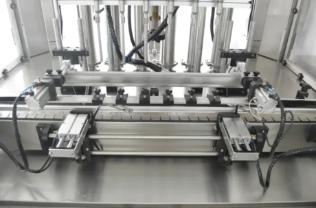 Close-up of a multi-nozzle filling machine for liquid packaging