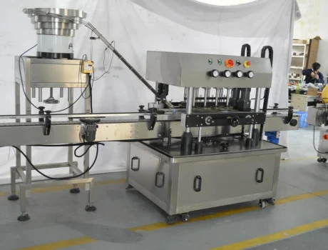 Bottles on a conveyor system with a labeling machine applying labels
