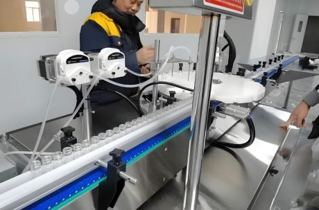 : Technician monitoring industrial filling machine during operation