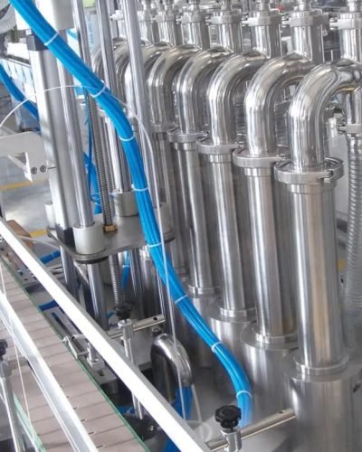 Stainless steel liquid filling nozzles aligned in production line