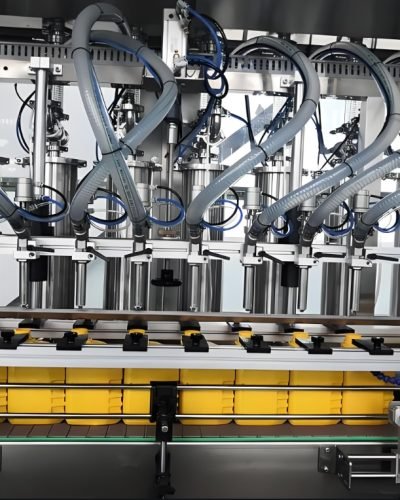 Multi-head liquid filling machine dispensing product into bottles