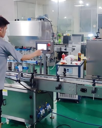 Technician operating automated filling and packaging machine
