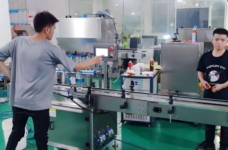 Technician operating automated filling and packaging machine