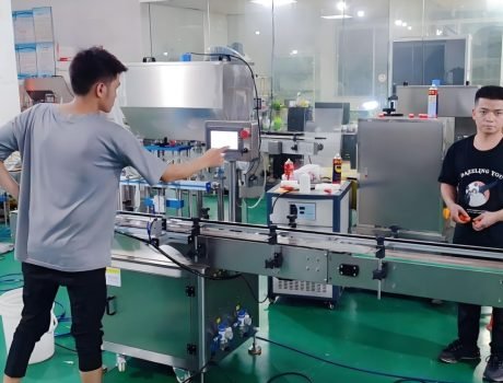 Technician operating automated filling and packaging machine