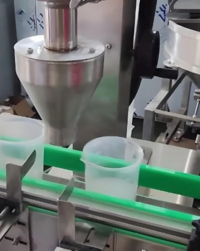 Powder filling machine dispensing product into plastic containers