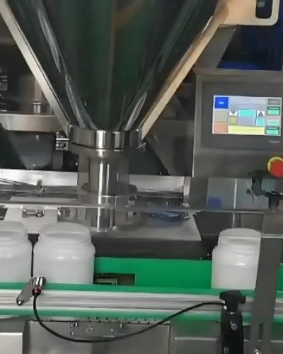 Powder filling machine dispensing product into plastic bottles