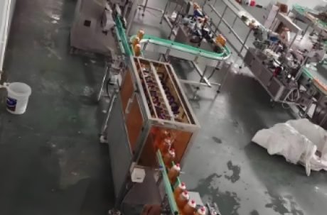Overhead view of automated beverage bottling line in operation