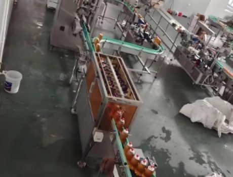 Overhead view of automated beverage bottling line in operation