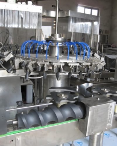 Automated production line for filling, capping, and labeling beverage bottles.