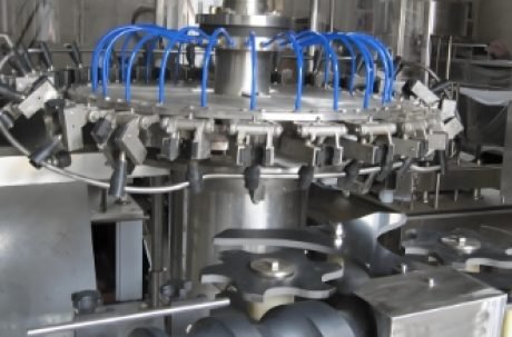 Automated production line for filling, capping, and labeling beverage bottles.