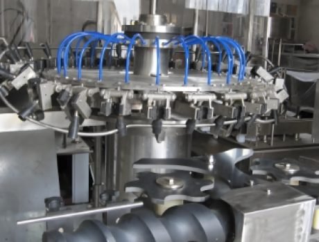 Automated production line for filling, capping, and labeling beverage bottles.