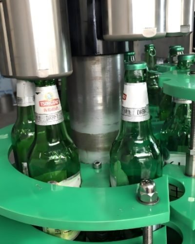 Bottle filling system applying caps and sealing bottles during production.