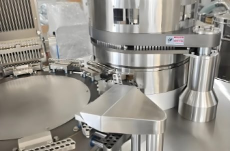 Capsule filling system with rotating drum for precise capsule production.