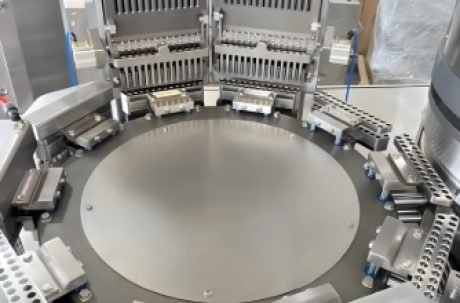 Pharmaceutical capsule production line with sorting and filling stations.