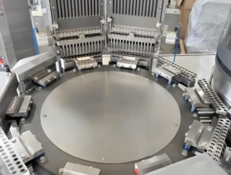 Pharmaceutical capsule production line with sorting and filling stations.