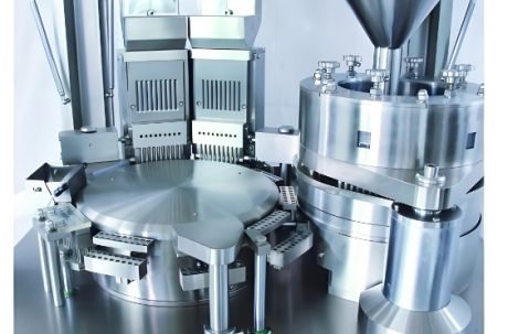 Close-up of pharmaceutical capsules being processed by automated machinery.