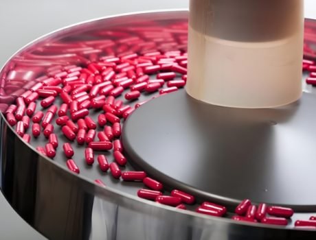 Pharmaceutical capsule production line with automated sorting and filling systems.