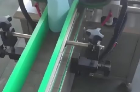 Close-up of an automated labeling machine with a digital interface.