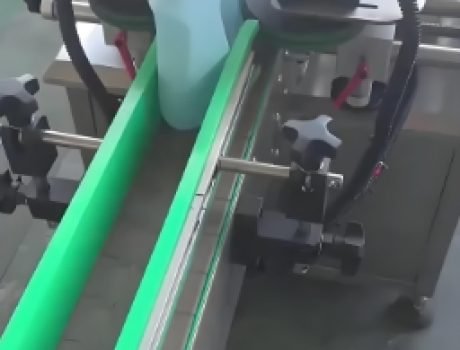 Close-up of an automated labeling machine with a digital interface.