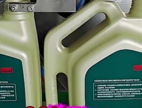 Close-up of an automatic liquid filling machine dispensing liquid into containers.